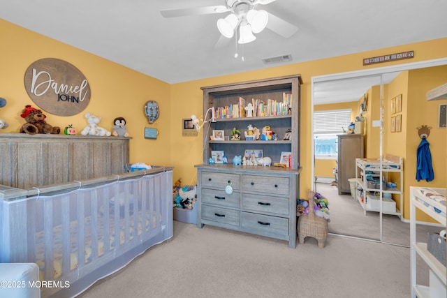 bedroom featuring visible vents, carpet floors, a closet, and ceiling fan