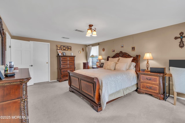 bedroom featuring visible vents and light carpet