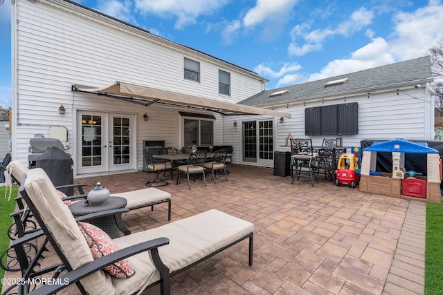 view of patio / terrace with french doors, outdoor dining area, and area for grilling