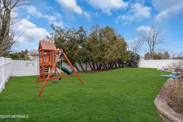 view of yard featuring a playground and a fenced backyard