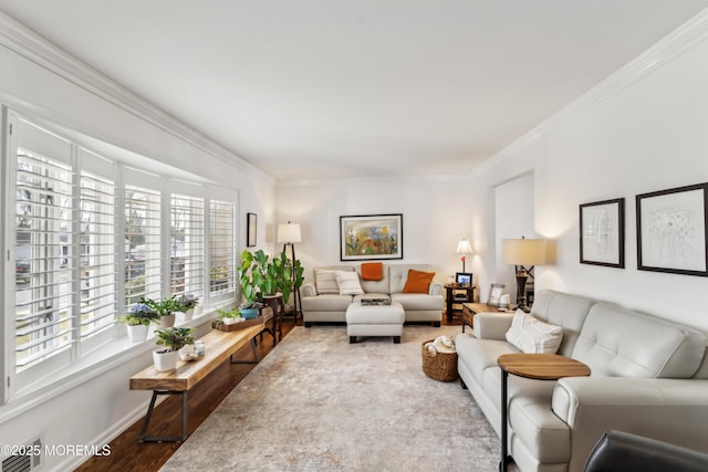 living room featuring baseboards, wood finished floors, and crown molding