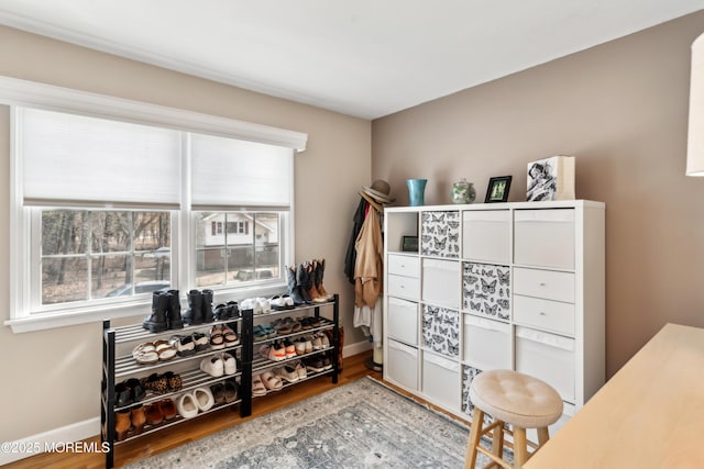 interior space featuring baseboards and wood finished floors