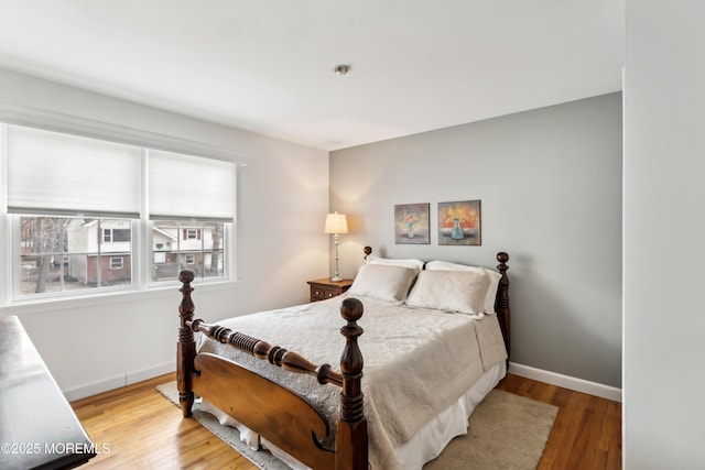 bedroom featuring baseboards and light wood-style flooring