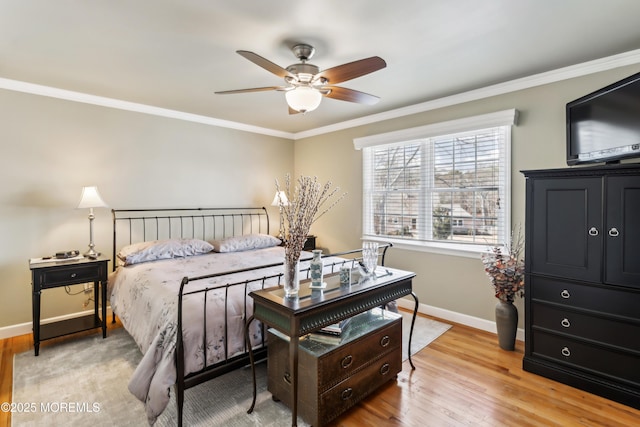 bedroom featuring light wood-type flooring, baseboards, and crown molding