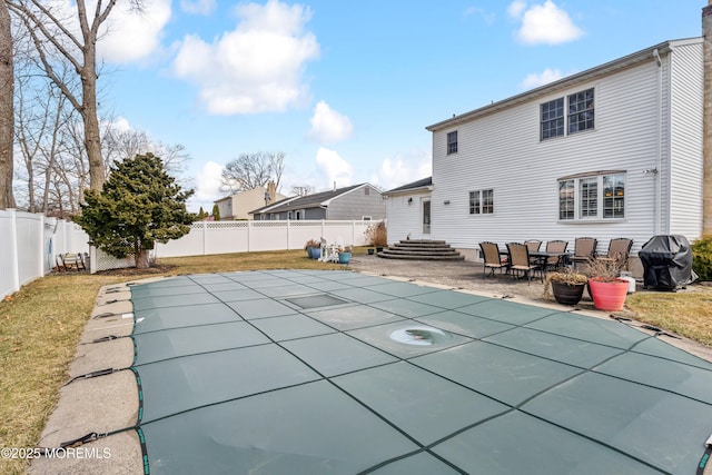 view of swimming pool featuring a yard, a grill, a fenced backyard, and a patio area