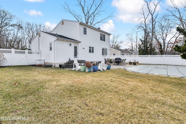 back of house featuring a yard, a patio area, a fenced backyard, and entry steps