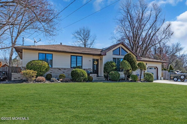 ranch-style house featuring brick siding, driveway, a front yard, and an attached garage