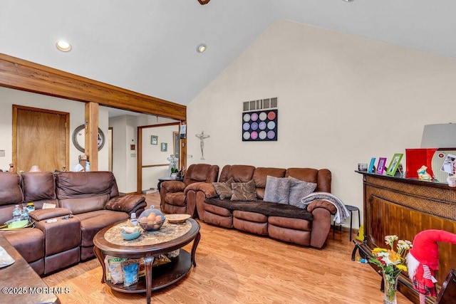 living area featuring light wood-style flooring, recessed lighting, and high vaulted ceiling