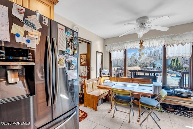 dining room with light tile patterned floors and a ceiling fan