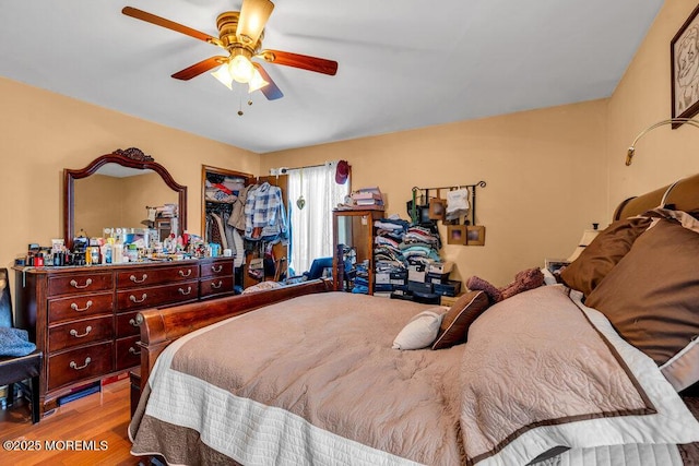 bedroom with ceiling fan and wood finished floors