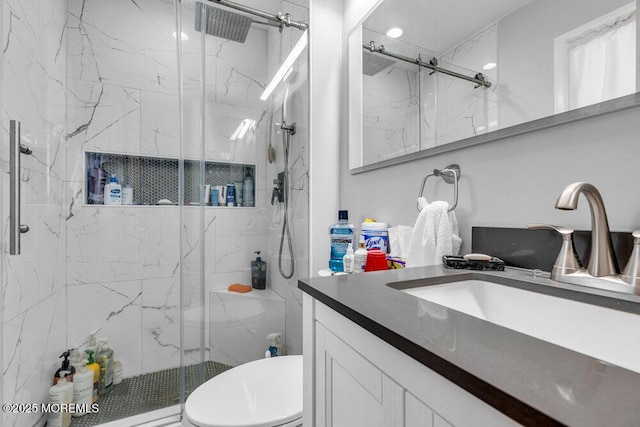 bathroom with a marble finish shower, toilet, and vanity