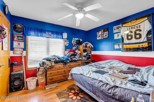 bedroom featuring a ceiling fan and wood finished floors