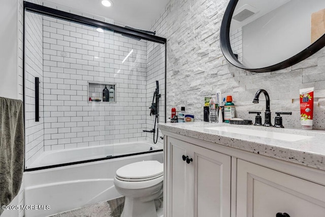 bathroom with visible vents, backsplash, toilet, enclosed tub / shower combo, and vanity