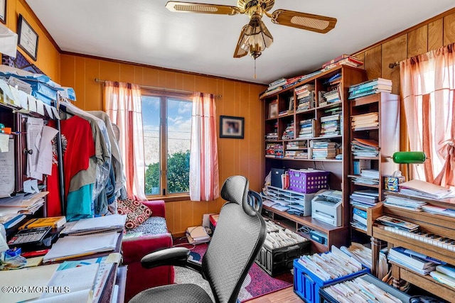 office with wood walls and a ceiling fan