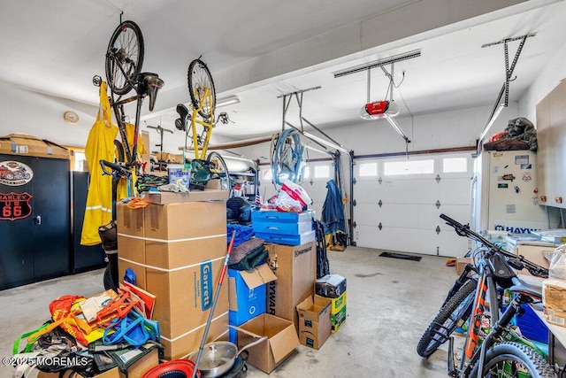 garage featuring a garage door opener and freestanding refrigerator