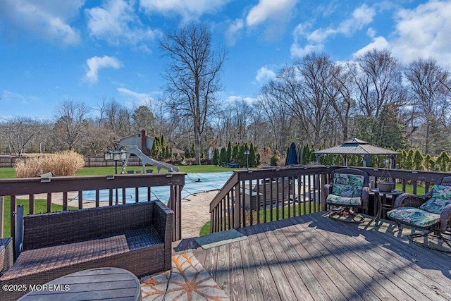 deck with a lawn and a playground