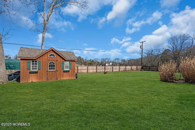 view of yard with a fenced backyard, a storage shed, and an outdoor structure