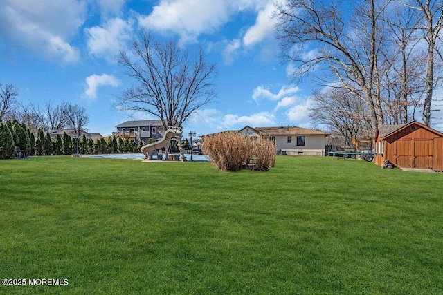 view of yard featuring a storage shed and an outdoor structure