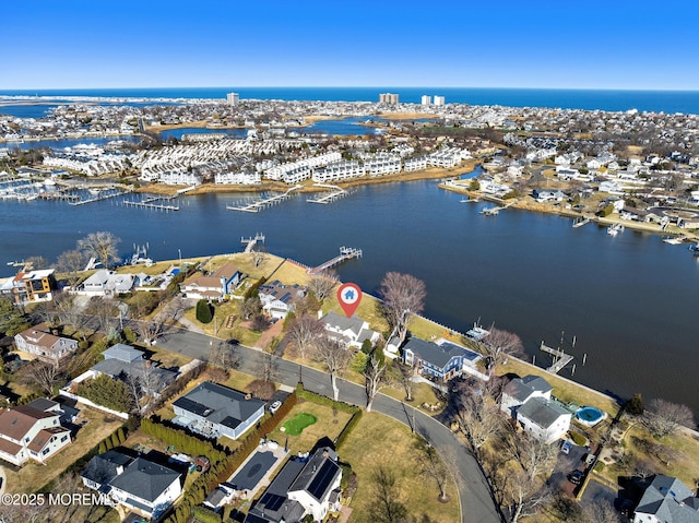 drone / aerial view featuring a residential view and a water view