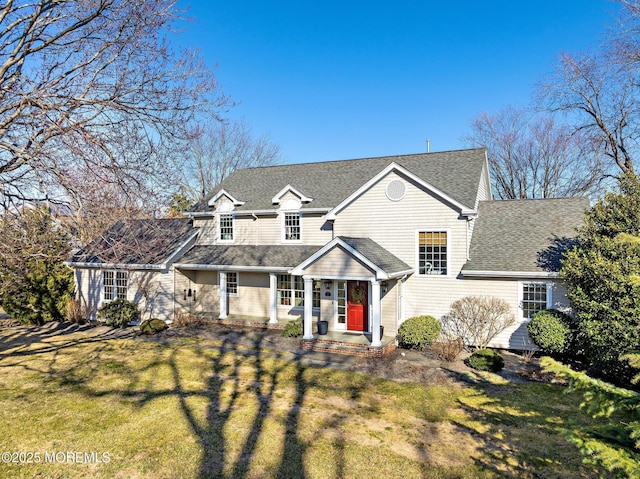 view of front of property with a front yard and roof with shingles