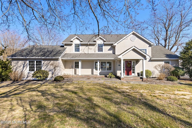 view of front of home featuring a shingled roof and a front lawn