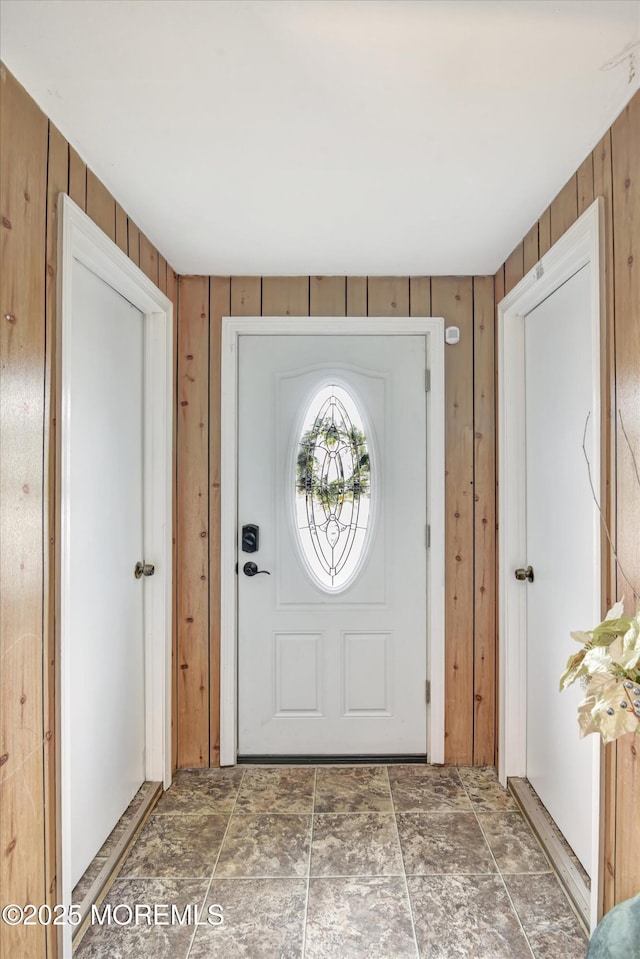 foyer entrance with wood walls