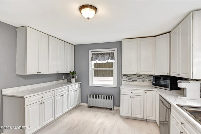 kitchen featuring radiator, decorative backsplash, white cabinets, dishwasher, and light wood-type flooring