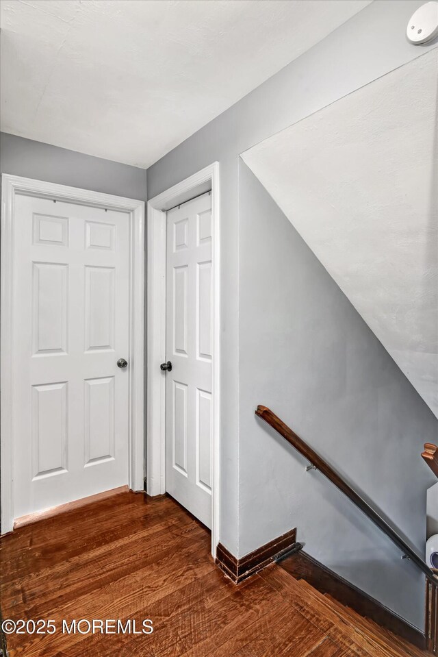 staircase with wood finished floors