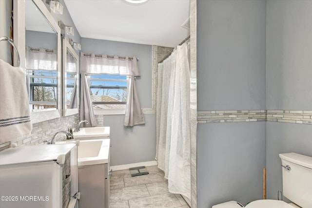 full bathroom with curtained shower, double vanity, toilet, and a sink