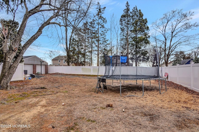 view of yard with a fenced backyard and a trampoline