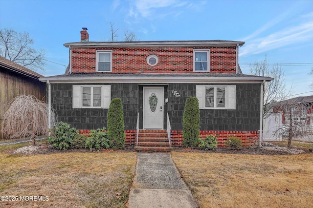 view of front of property featuring a front lawn and a chimney