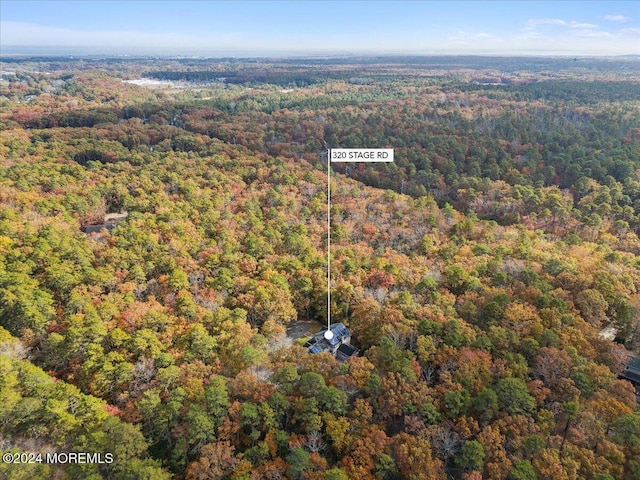 birds eye view of property with a forest view