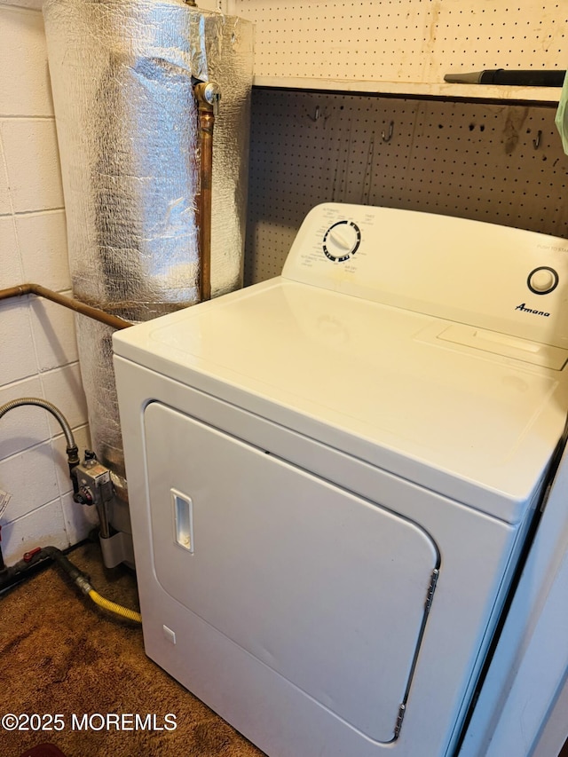 washroom with washer / clothes dryer, concrete block wall, and laundry area