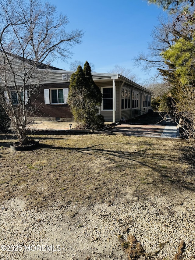 view of home's exterior with brick siding