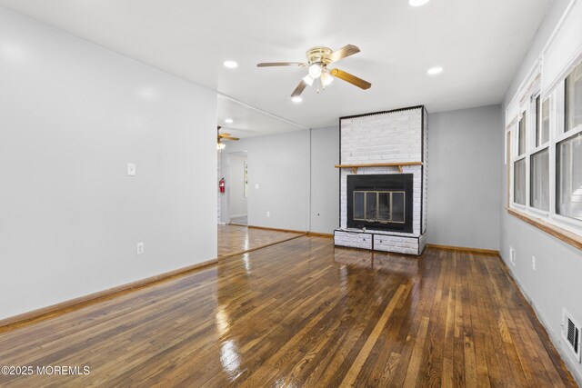 unfurnished living room featuring baseboards, ceiling fan, hardwood / wood-style floors, recessed lighting, and a fireplace