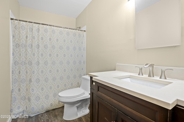 full bathroom with vanity, a shower with curtain, toilet, and wood finished floors