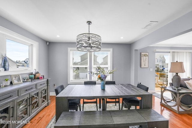 dining area with visible vents, light wood-style flooring, recessed lighting, baseboards, and a chandelier