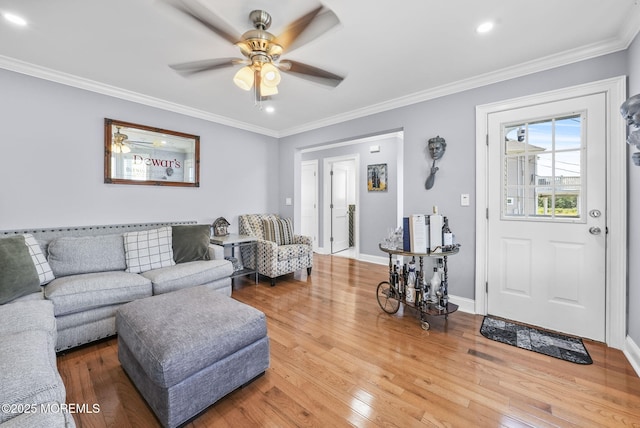 living room with hardwood / wood-style floors, recessed lighting, crown molding, baseboards, and ceiling fan