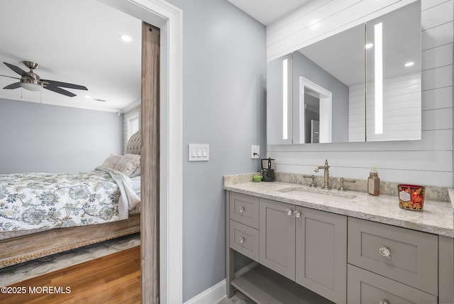 bathroom featuring visible vents, connected bathroom, baseboards, ceiling fan, and vanity