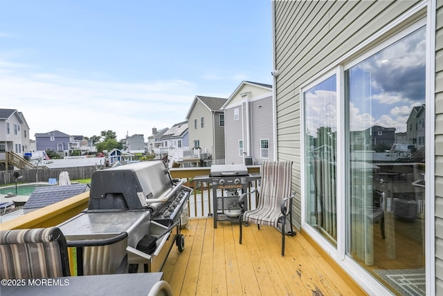 wooden deck with area for grilling and a residential view