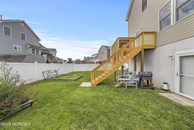 view of yard with stairway, a vegetable garden, and fence