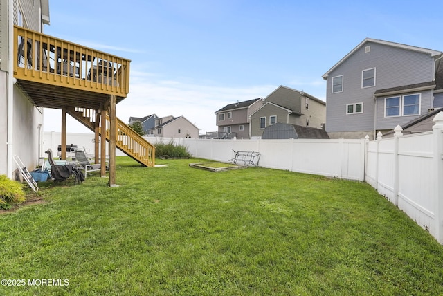 view of yard featuring a wooden deck, a residential view, a fenced backyard, and stairs