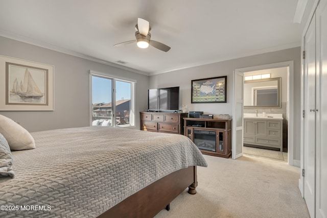 bedroom with visible vents, light carpet, a ceiling fan, connected bathroom, and crown molding