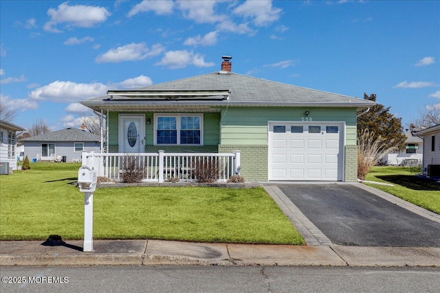 view of front facade featuring a front lawn, brick siding, a porch, and an attached garage