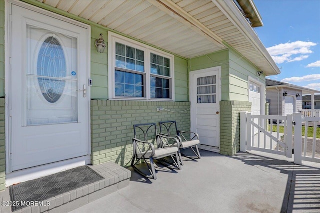 doorway to property featuring brick siding