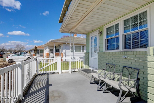 view of patio with a residential view and a porch