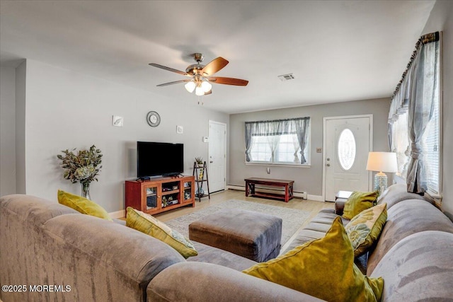 living room with visible vents, light wood-style flooring, baseboards, and a ceiling fan