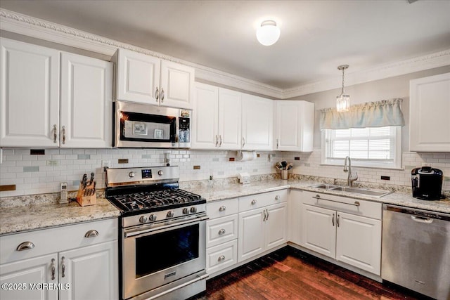 kitchen featuring a sink, backsplash, dark wood-style floors, white cabinetry, and appliances with stainless steel finishes