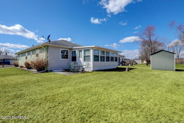 back of property featuring a yard, an outdoor structure, and a shed