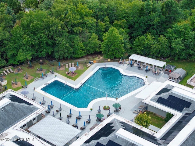 pool with a patio area and fence